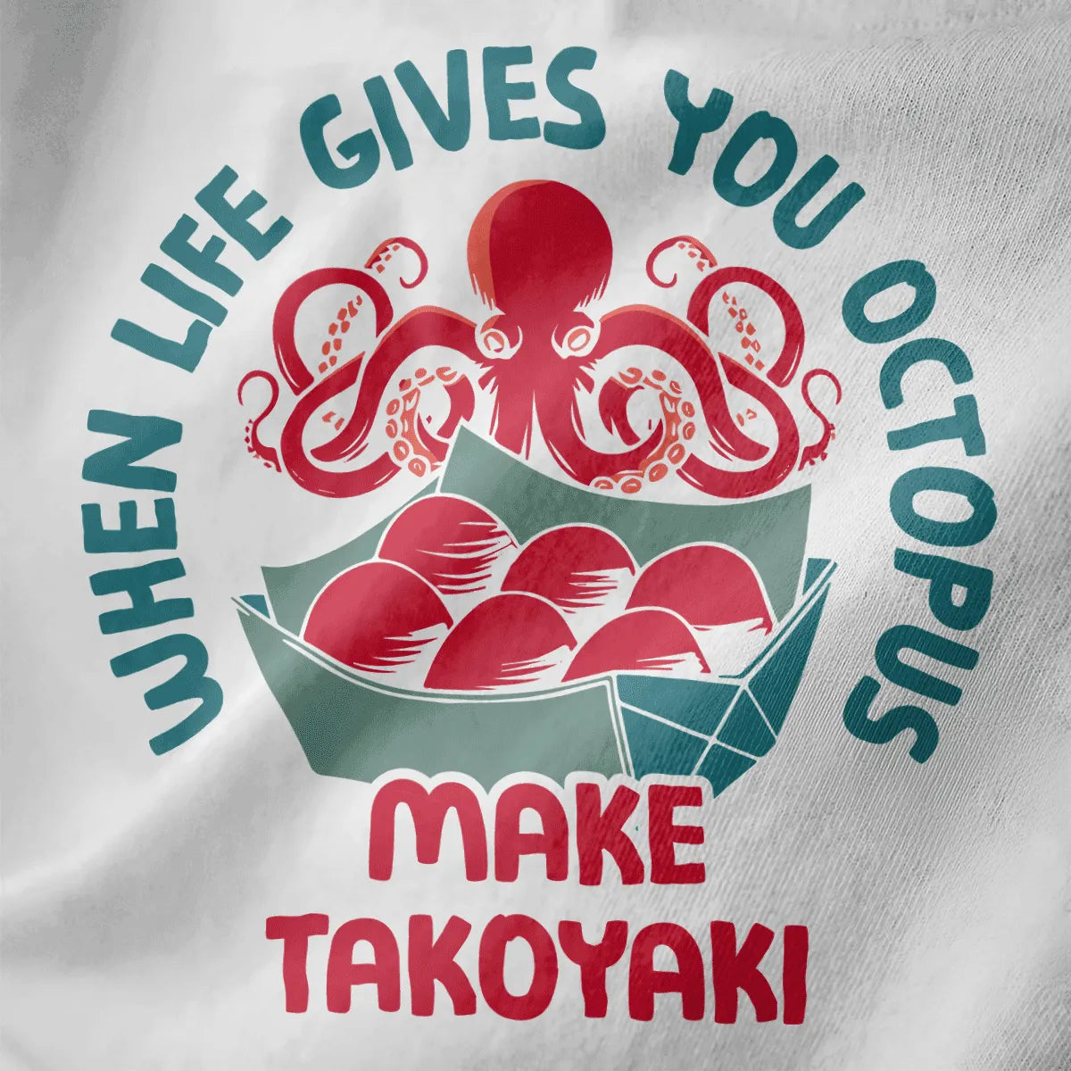 Close-up of playful octopus and takoyaki balls on white shirt, featuring circular text and vibrant style.