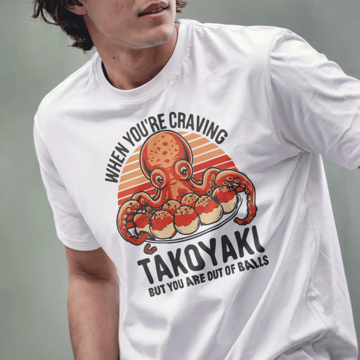 Male model in white shirt featuring whimsical octopus, takoyaki balls, and bold retro font, japanese t-shirts.