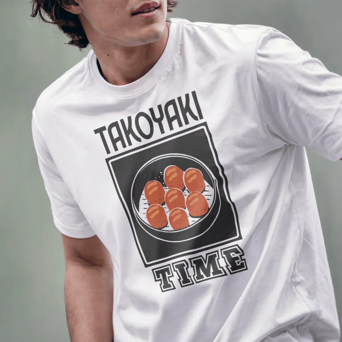 Male model wears white “TAKOYAKI TIME” shirt with takoyaki balls, bold text fonts, streetwear style.