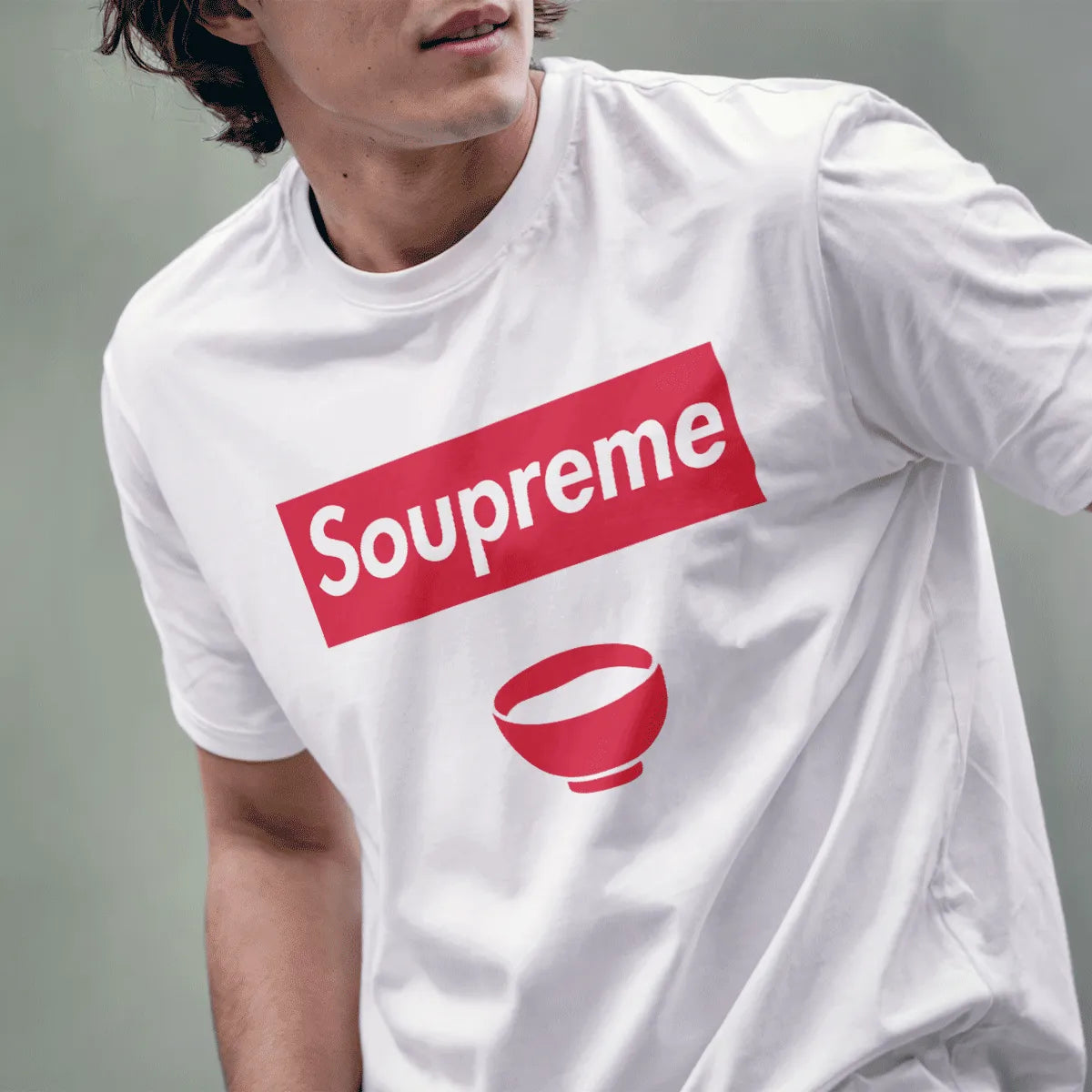 Male model in white Soupreme logo parody t-shirt with red soup bowl, streetwear shirt, slogan t shirts funny.