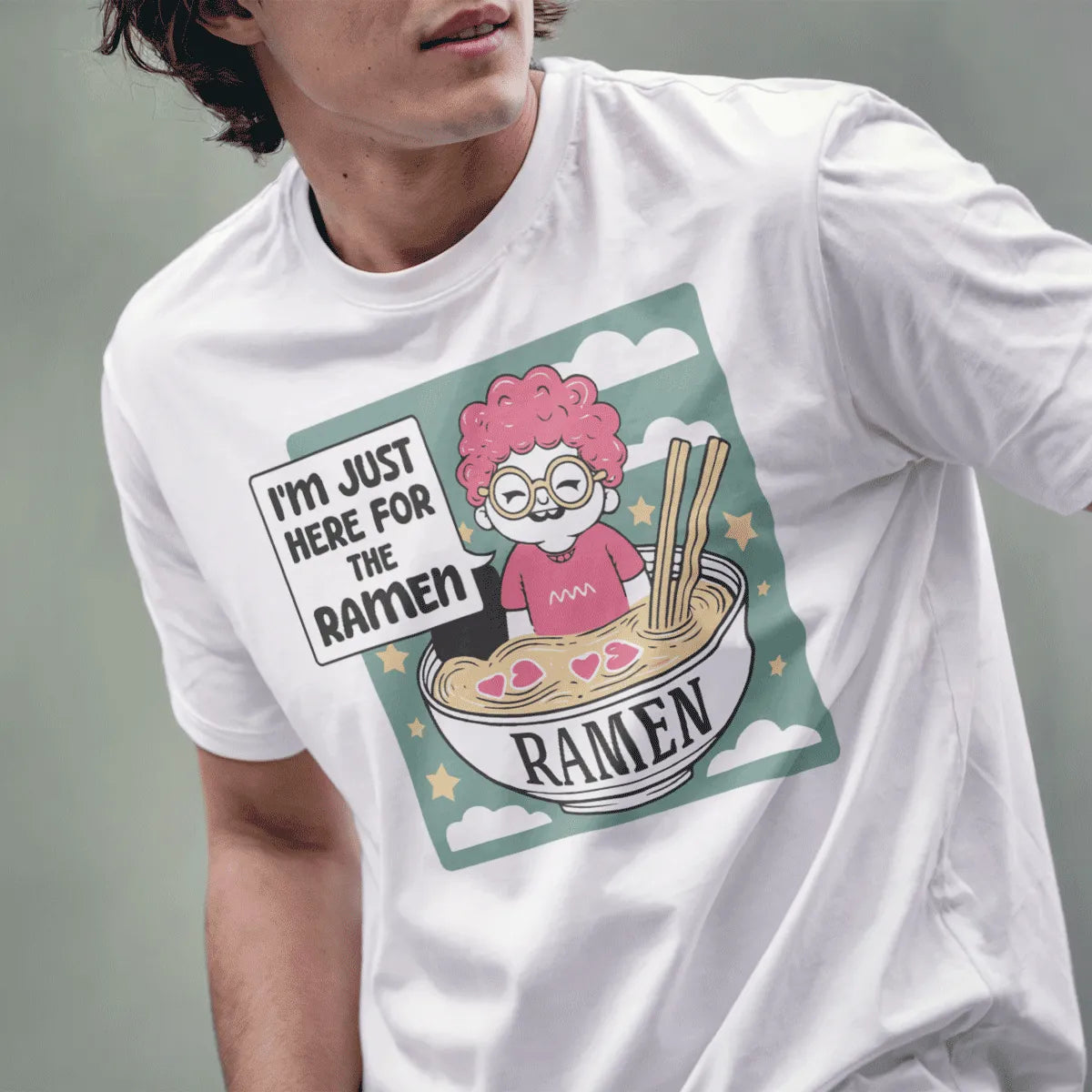 Male model in white t-shirt with playful ramen bowl character, ramen shirt, kawaii design, humorous quote.