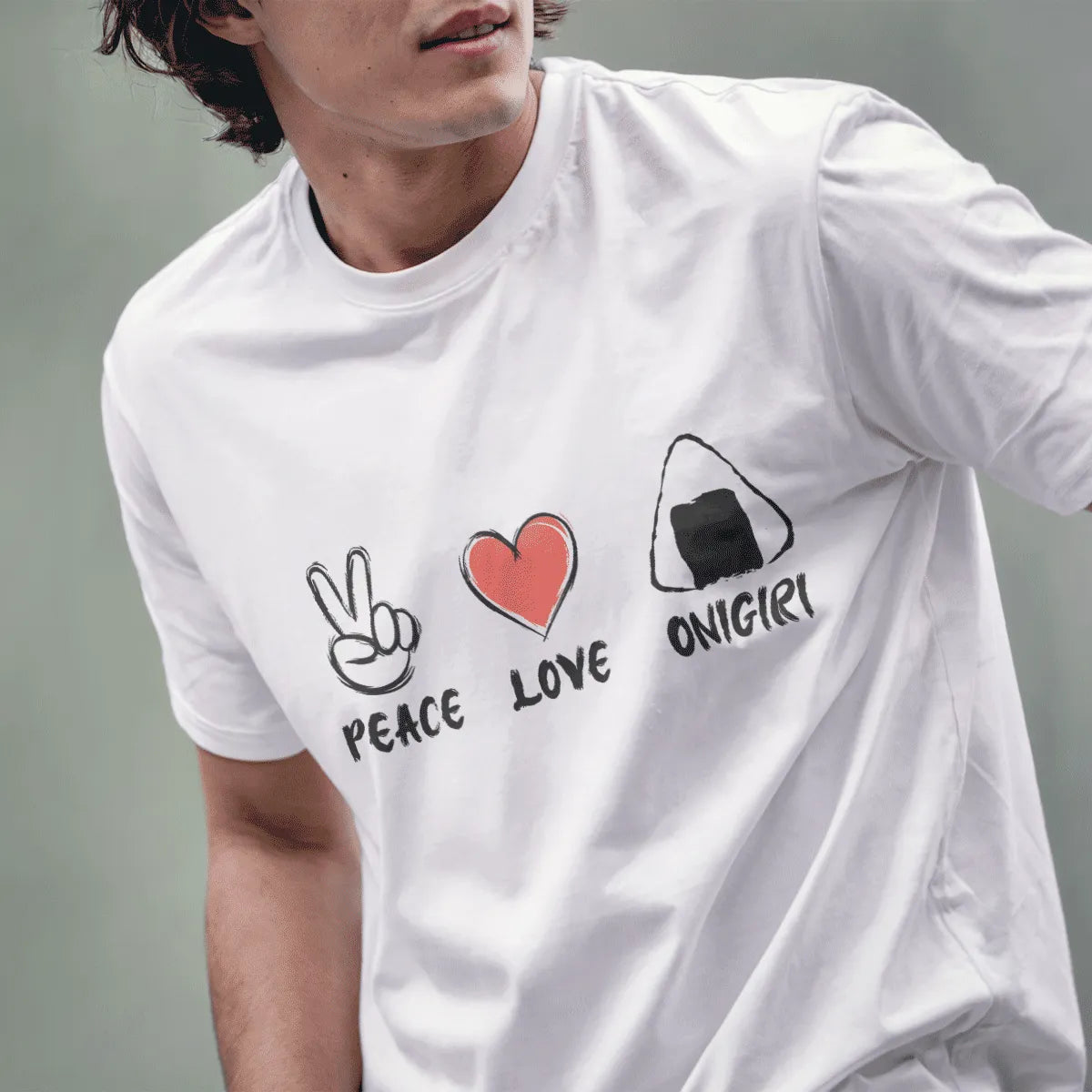 Male model in white t-shirt with peace, heart, and onigiri icons; japanese t-shirts, positive messaging, cultural symbolism.