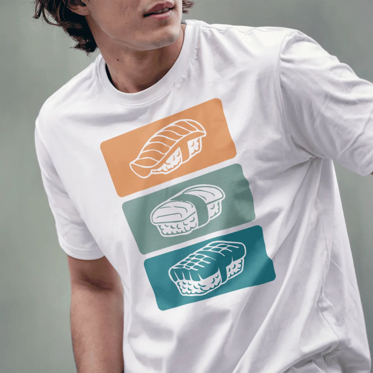 Male model wears white t-shirt with detailed sushi art trio, showcasing japanese t-shirts and vibrant style.