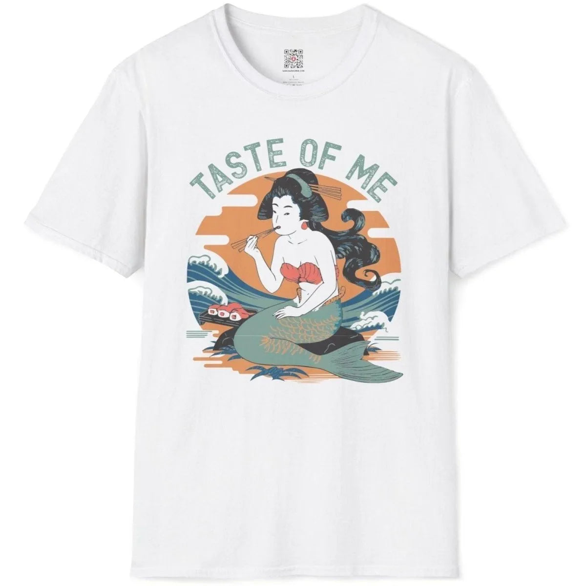 White t-shirt flatlay with mermaid eating sushi, set against serene landscape and dynamic waves.