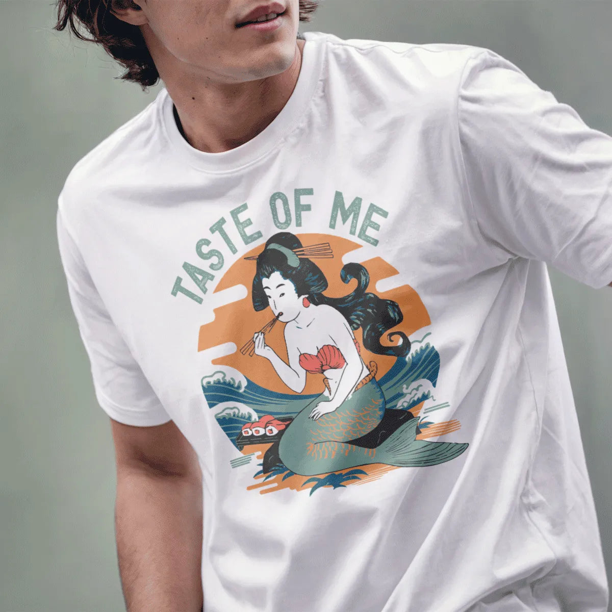 Male model wears white t-shirt with mermaid enjoying sushi, blending mythical cuisine and Japanese t-shirts.