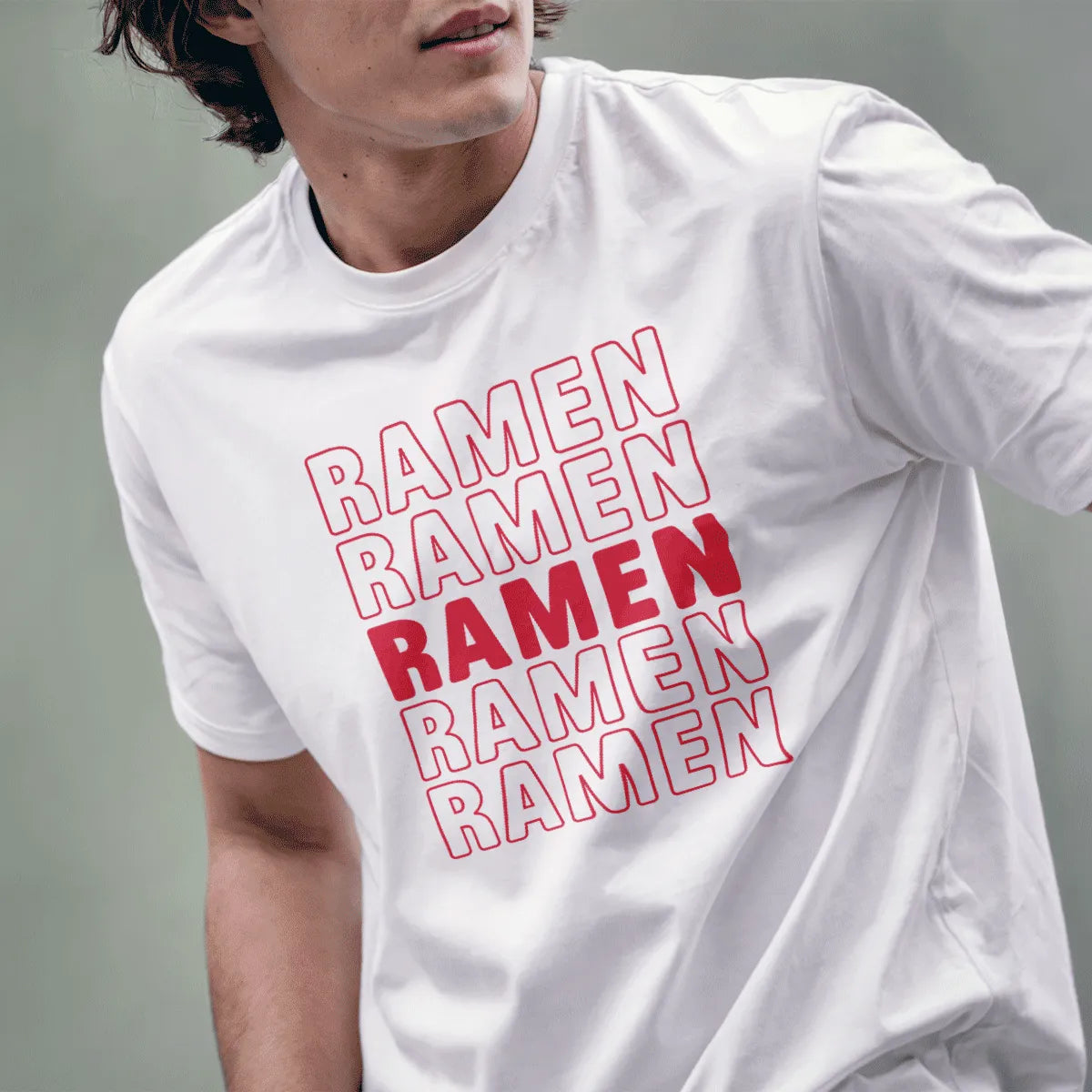 Male model in white t-shirt with RAMEN repetition, ramen t-shirt, culinary obsession, vibrant red accent.