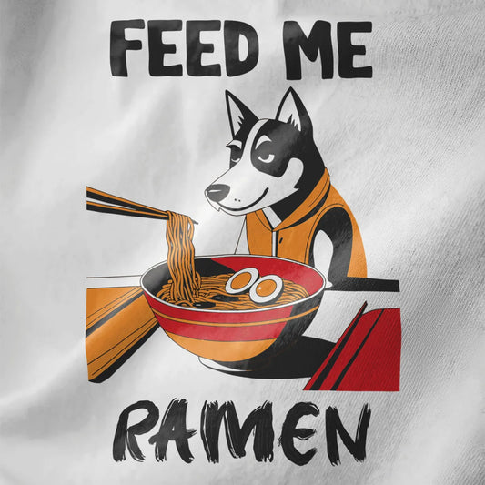 Closeup of husky in orange hoodie eyeing ramen bowl, “FEED ME RAMEN” text on white fabric, ramen t-shirt, dog shirt.