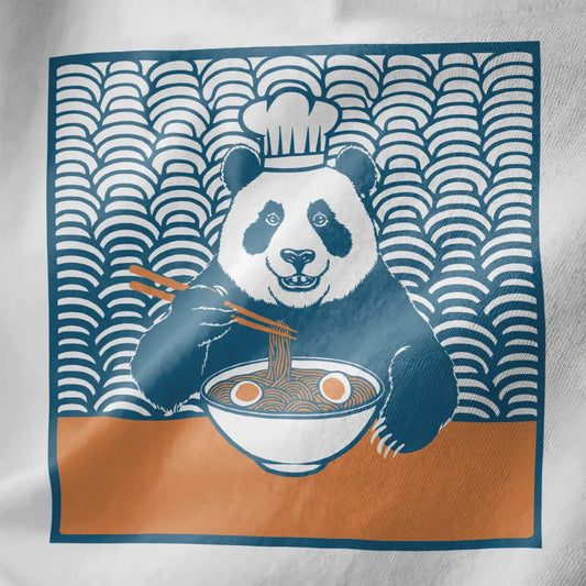 Chef panda enjoying ramen on white fabric, ramen t-shirt and panda chef, close-up of bowl details.