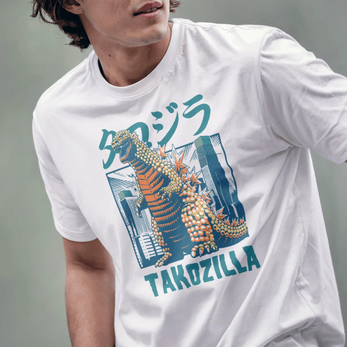Male model in white shirt with orange Takozilla, takoyaki, and cityscape, japanese t-shirts, monster shirt.