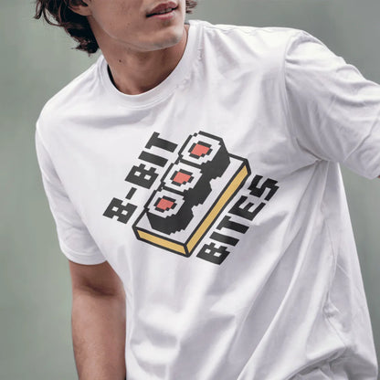 Male model in white t-shirt with retro pixel sushi and "8-BIT BITES" text, sushi shirt, vintage aesthetic.