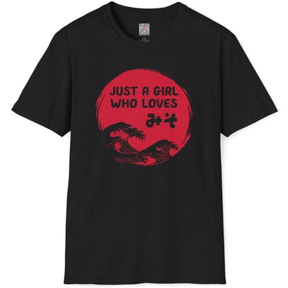 Flatlay of black t-shirt featuring red sun, miso kanji, and stylized waves. japanese graphic tees, foodie style.