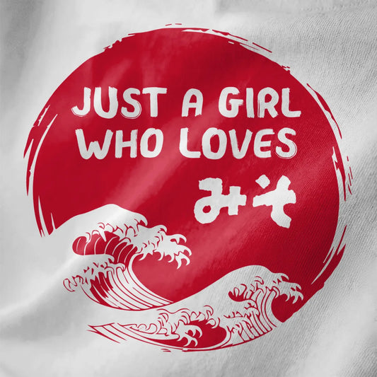 White fabric closeup showing bold red sun, miso kanji, and stylized waves. japanese t shirts, foodie style.