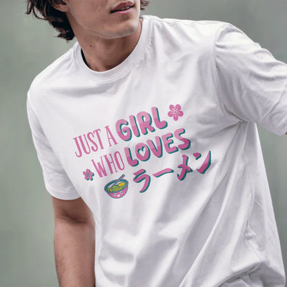 Male model in white ramen t-shirt featuring kawaii ramen bowl, pink text, and cherry blossoms, relaxed pose.