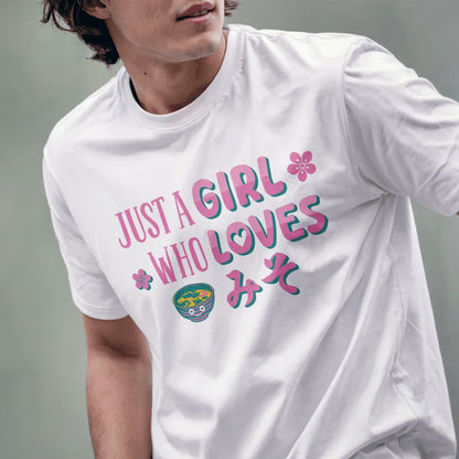 Male model in white miso t shirt with playful pink and teal text, smiling miso bowl, and cherry blossom accents.