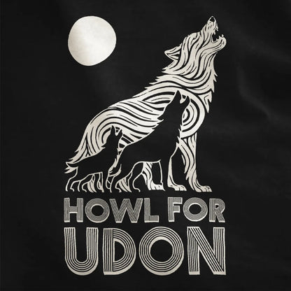 Close-up of black t-shirt showing three howling wolves, udon noodle wolf, bold typography, contrast art.