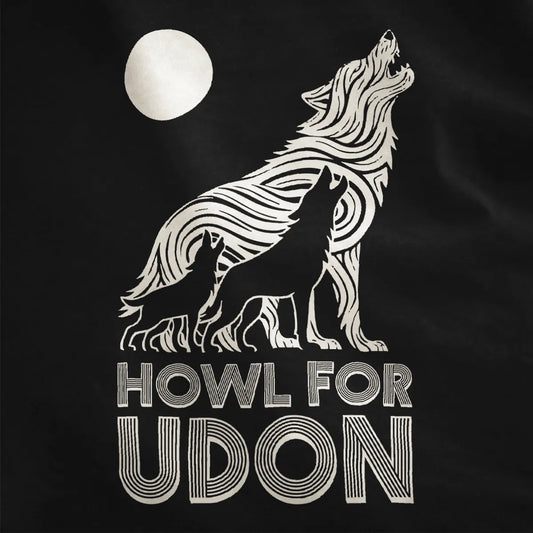 Close-up of black t-shirt showing three howling wolves, udon noodle wolf, bold typography, contrast art.