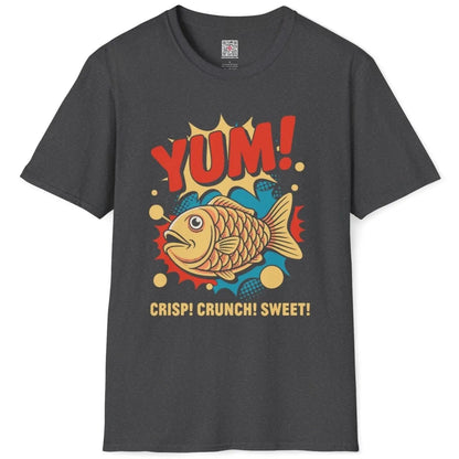 Dark heather t-shirt flatlay, lively taiyaki fish, "YUM!" text, cartoonish style, junk food shirt.