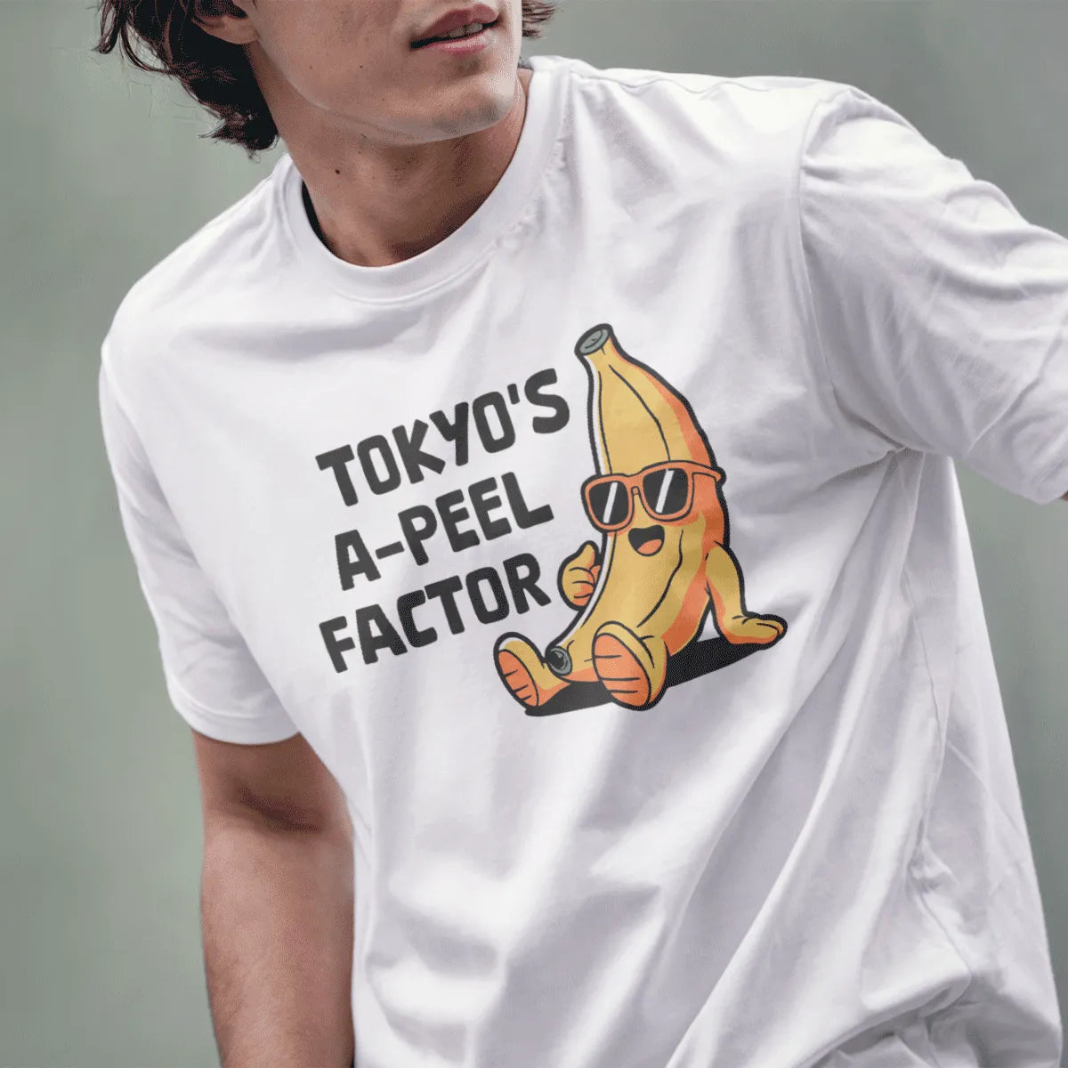 Male model in white t-shirt with cool banana character, sunglasses, and cheerful vibe, tokyo banana.
