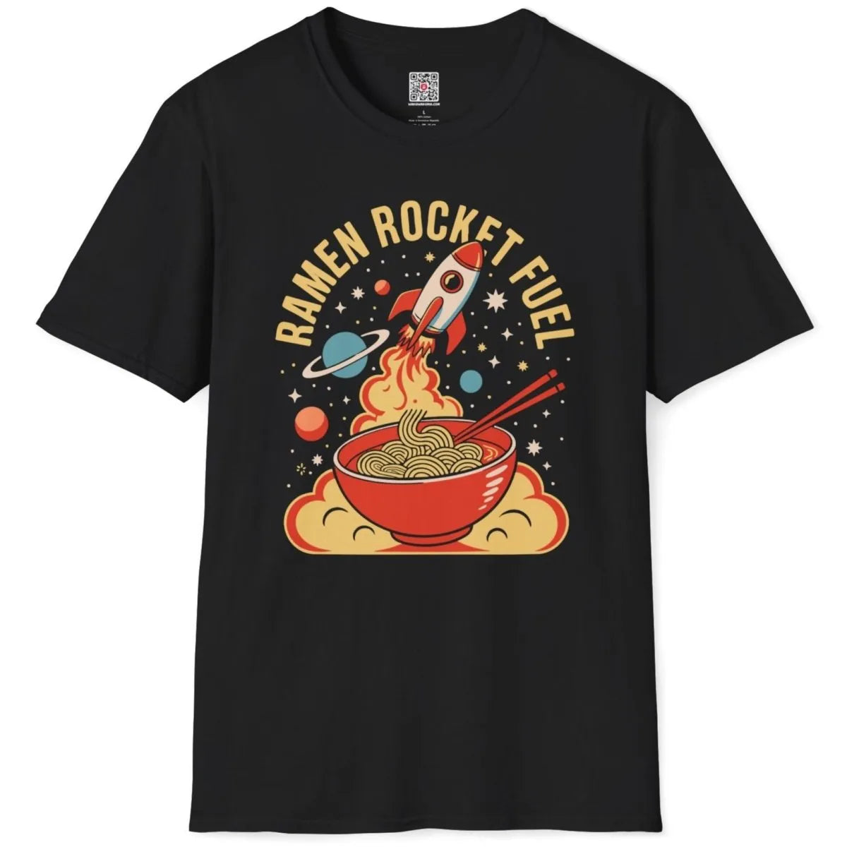 Black t-shirt flatlay with playful ramen bowl, rocket, and retro "RAMEN ROCKET FUEL" text, vibrant style.