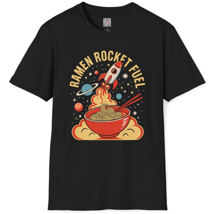 Black t-shirt flatlay with playful ramen bowl, rocket, and retro "RAMEN ROCKET FUEL" text, vibrant style.