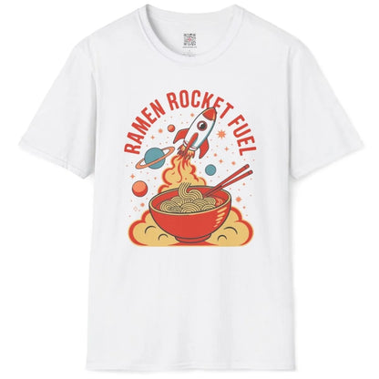 White t-shirt flatlay with colorful ramen, rocket launch, and bold retro font, cosmic design.