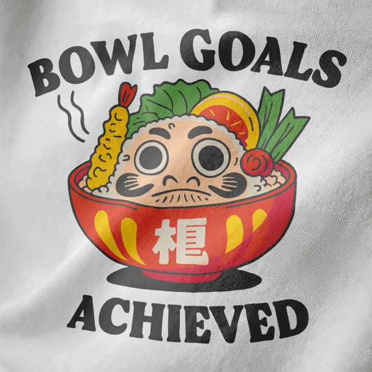 Red bowl with Daruma doll, sushi, and “BOWL GOALS ACHIEVED” text on white closeup, fusion cuisine.