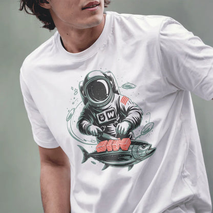 Male model wearing white Japanese t-shirt with whimsical astronaut preparing sushi illustration.