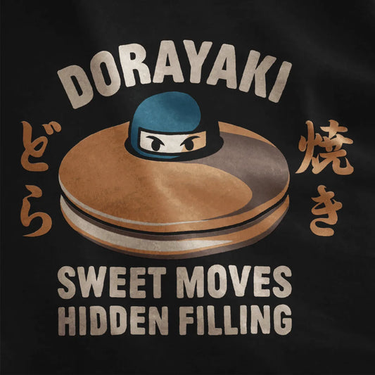 Black fabric close-up of dorayaki dessert with ninja peeking out, bold text, and playful graphic design.