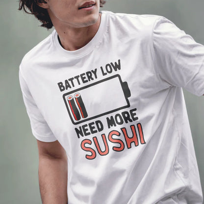 Male model in white shirt with “BATTERY LOW,” battery icon with sushi, “NEED MORE SUSHI” text. japanese t-shirts, sushi pun.