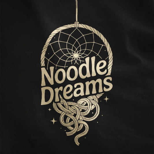 Black fabric close-up showing earthy brown dreamcatcher with intricate web and playful ramen noodles.