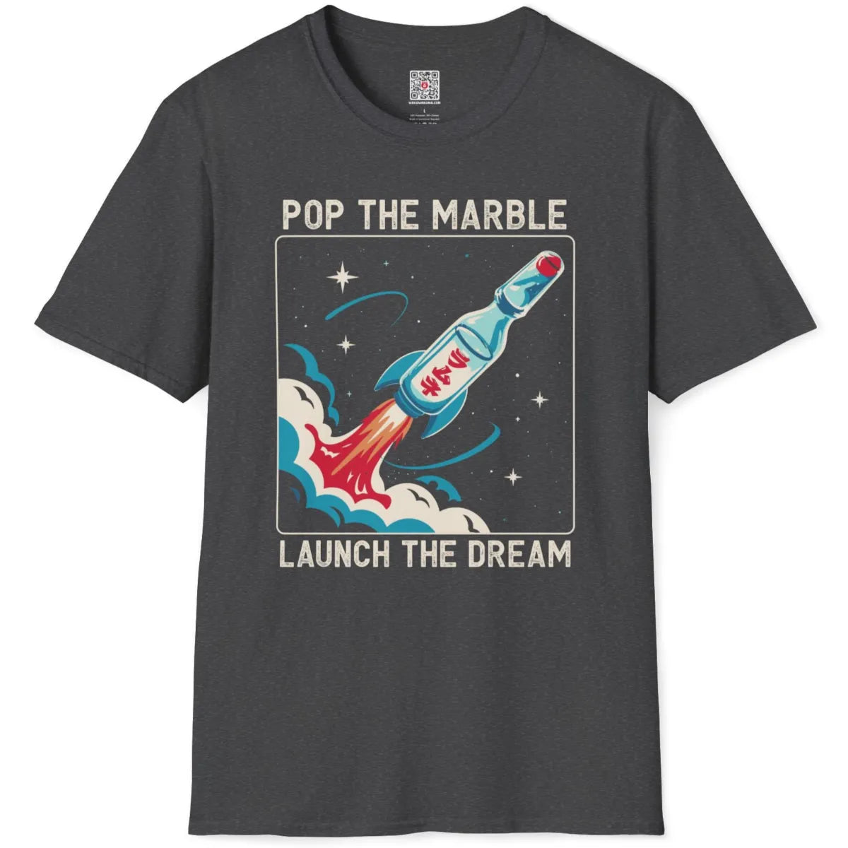 Dark heather t-shirt flatlay with galaxy-themed Ramune rocket ship and "Launch the Dream" inspirational text.