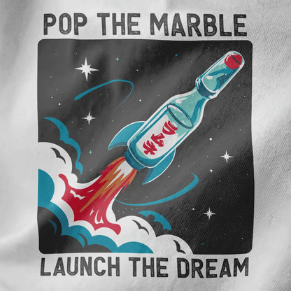 Close-up of white fabric featuring Ramune bottle rocket ship with iconic marble and star-speckled background.
