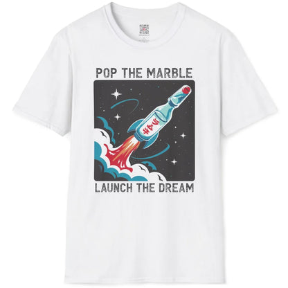 White t-shirt flatlay featuring cartoonish Ramune bottle transformed into energetic spacecraft with bold text.