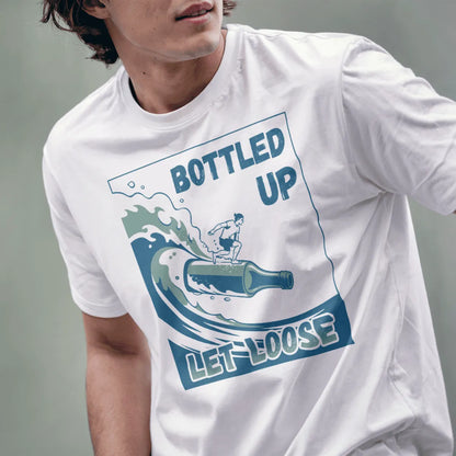 Male model wearing white t-shirt with playful bottle surfboard, athletic surfer, and "Let Loose" beach font.