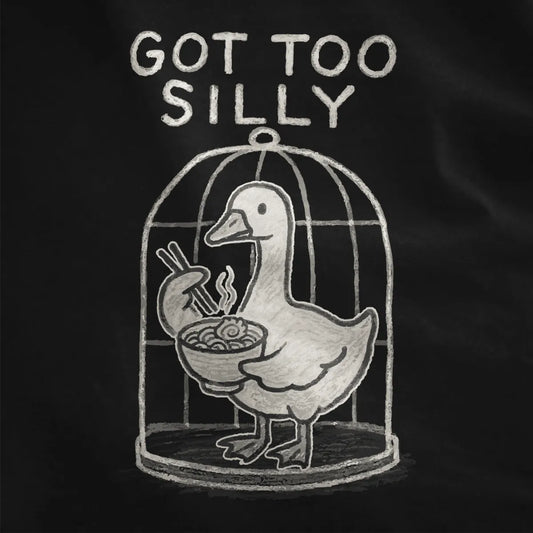 Sketch-style duck inside rounded birdcage with ramen and playful quote, black shirt up-close detail.