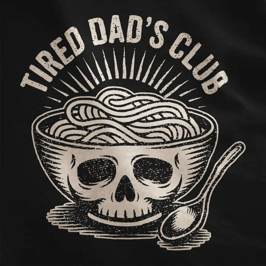 Bold ramen bowl with skull design and vintage "TIRED DAD'S CLUB" text on black shirt fabric, textured detail.