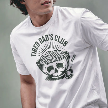 Male model wears white tee with graphic ramen bowl skull and gritty distressed text, hands visible.
