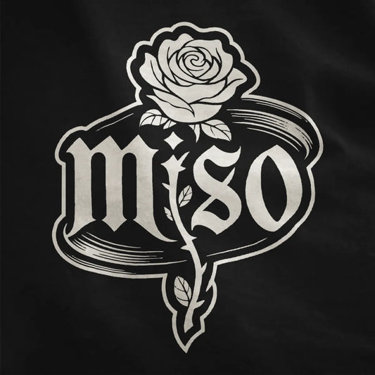 Black shirt close-up shows detailed black and white rose with leaves and thorns, gothic miso font inside sketch oval.