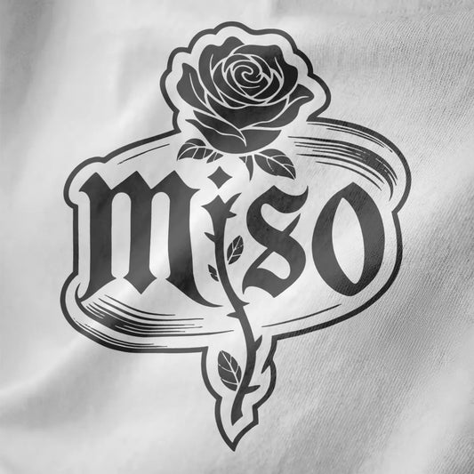 White shirt close-up of gothic "MISO" text framed by hand-drawn monochrome rose with distressed vintage line art.