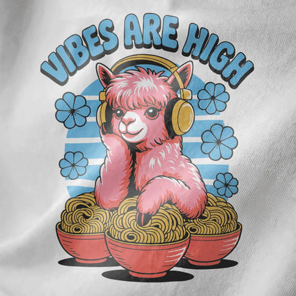 Close-up of pastel pink alpaca with yellow headphones and pink ramen bowls on white fabric.