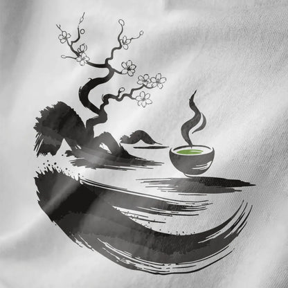 Close-up of white fabric with sumi-e twisted tree, white cherry blossoms, and green matcha bowl.