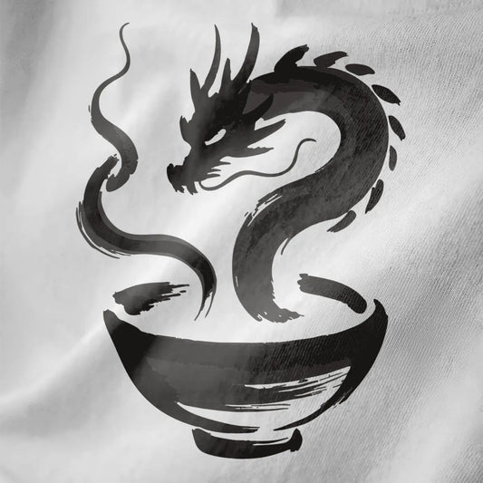 Close-up on white fabric showing brushstroke dragon rising from ramen bowl in monochrome palette.