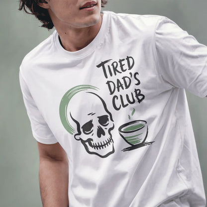 Male model wearing white tee with hand-drawn skull and matcha bowl in sage green, funny dad shirt design.