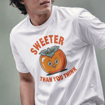 Male model wears white tee with smiling persimmon graphic, bold text "SWEETER THAN YOU THINK," retro vintage style.