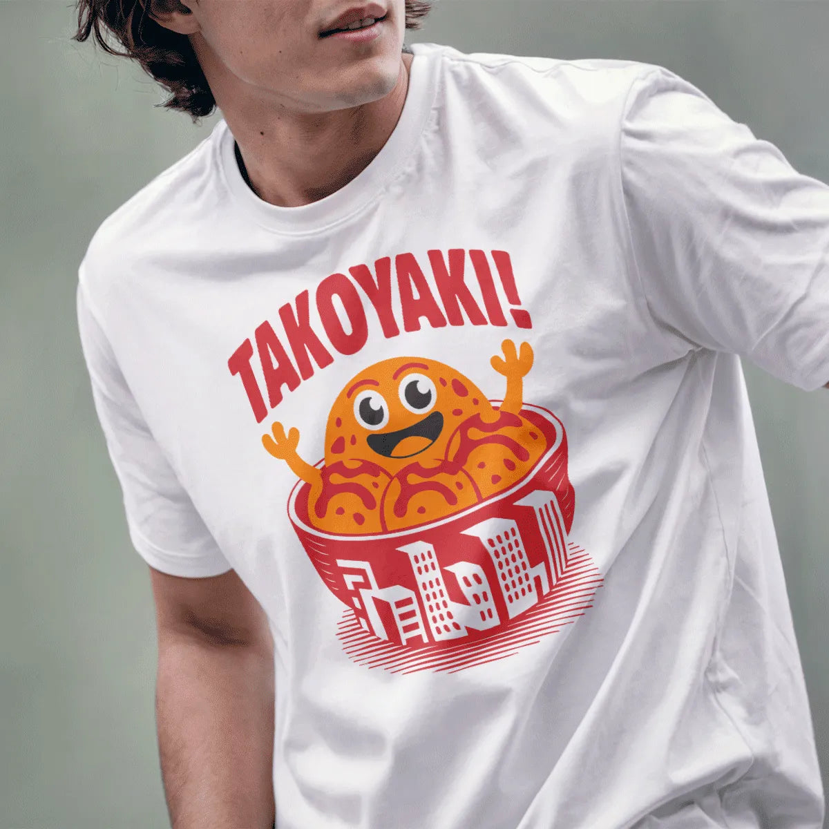 Male model wearing white t-shirt with bold red "TAKOYAKI" text and playful takoyaki bowl design.