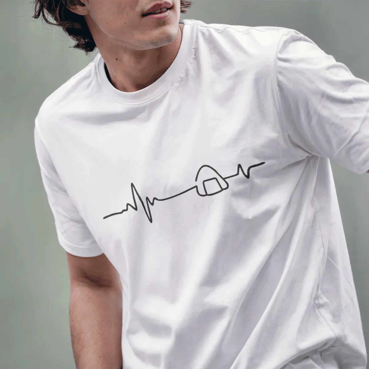 Male model wears white t-shirt with heartbeat line art forming onigiri, japanese snack popular, positive messaging.