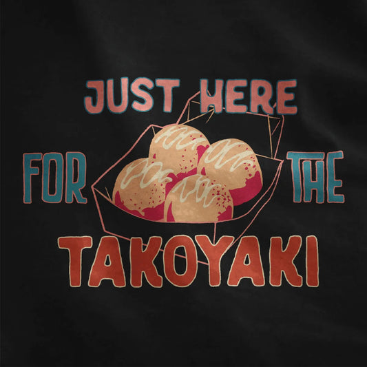 Black fabric close-up showing takoyaki balls and playful quote, contrast in colors, japanese t-shirts.