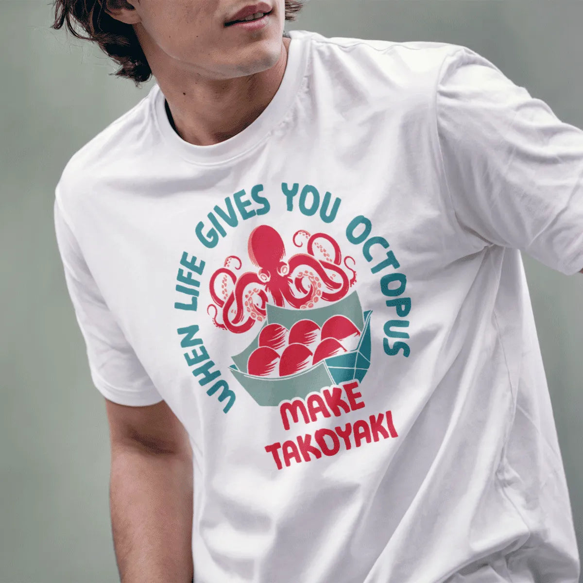 Male model in white t-shirt with cheerful octopus and takoyaki design, humorous quote, and Japanese t-shirt style.