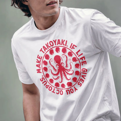 Male model in white t-shirt featuring whimsical octopus and takoyaki design, circular text, graphic tees stores.