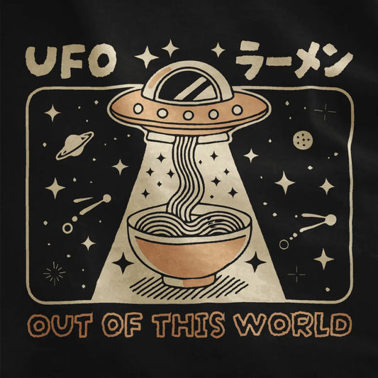 Black shirt close-up with whimsical UFO beaming noodles into ramen bowl, stars and planets in background.